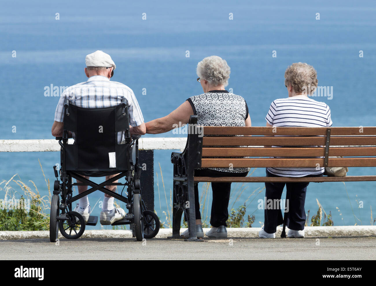 Elderly people at the coast on a warm summer`s day Stock Photo
